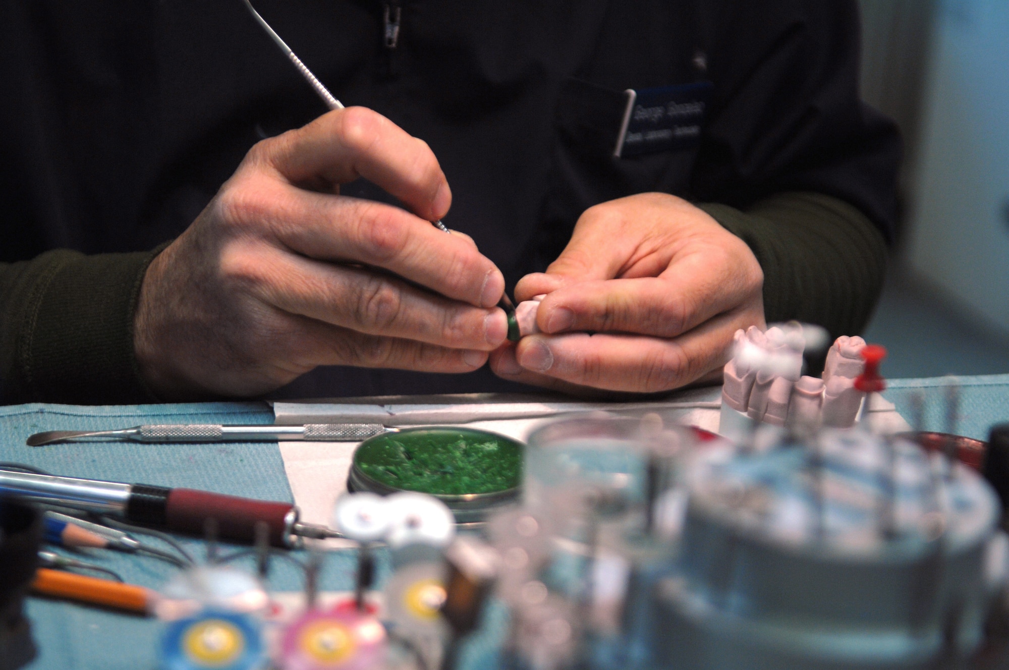 George Gonzalez a dental prosthetic technician works on a crown-molding at the Sembach Area Dental Laboratory, Sembach Annex, Germany. The Sembach ADL, one of three dental laboratories in the Air Force, will relocate to a new facility Building 301A behind the dental clinic located on Ramstein Air Base, Germany mid April. (U.S. Air Force photo by Tech. Sgt. Michael Voss)