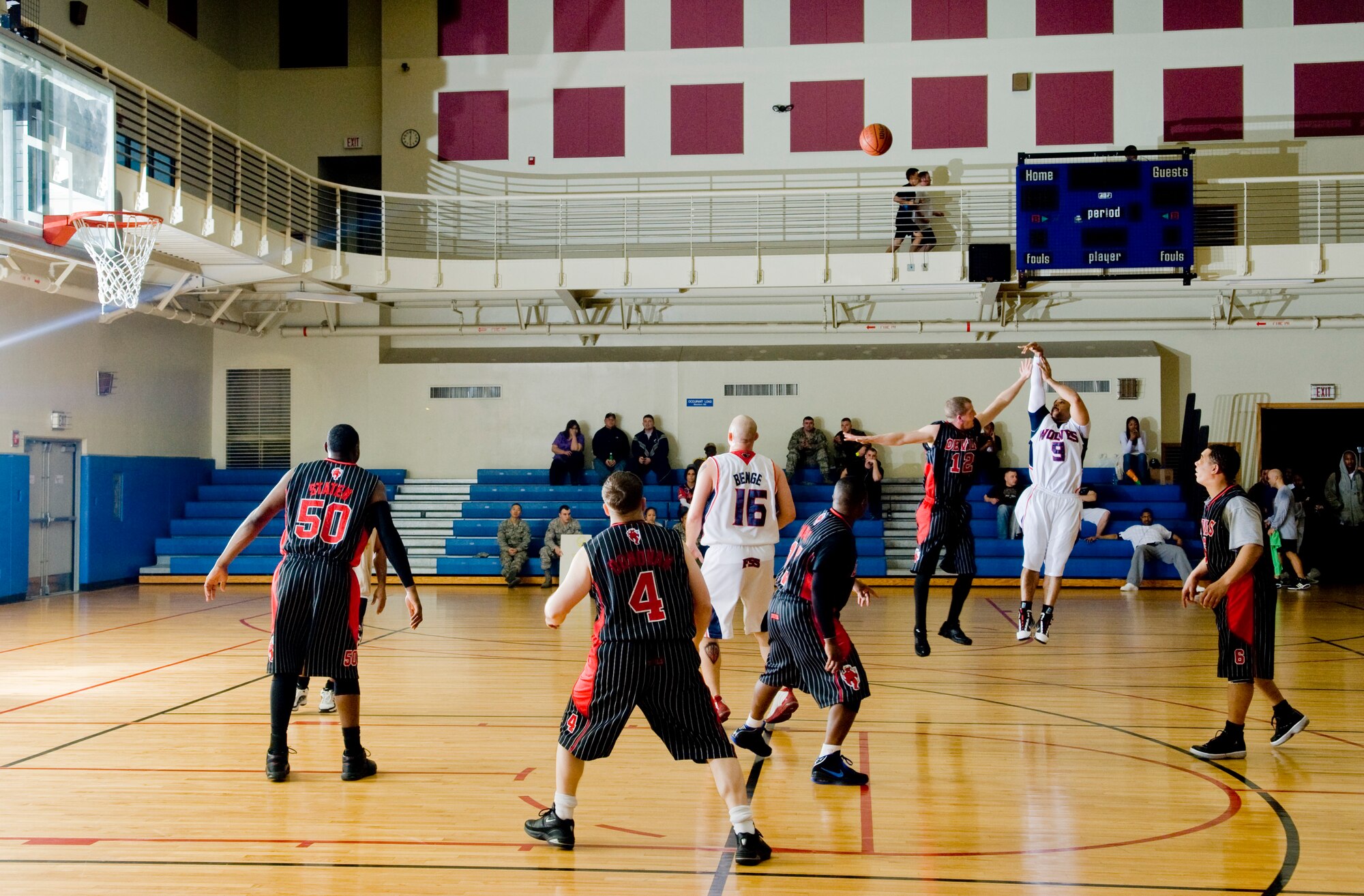 KUNSAN AIR BASE, Republic of Korea -- Dwayne Norman, playing for 8th Force Support Squadron, shoots for a three while Cameron Engleman, 8th Civil Engineer Squadron, tries to block him during the over 30 basketball championship Feb. 24.  The 8 FSS pulled through for the win against the 8 CES 51 to 43. (U.S. Air Force photo/Senior Airman Jonathan Steffen)  
