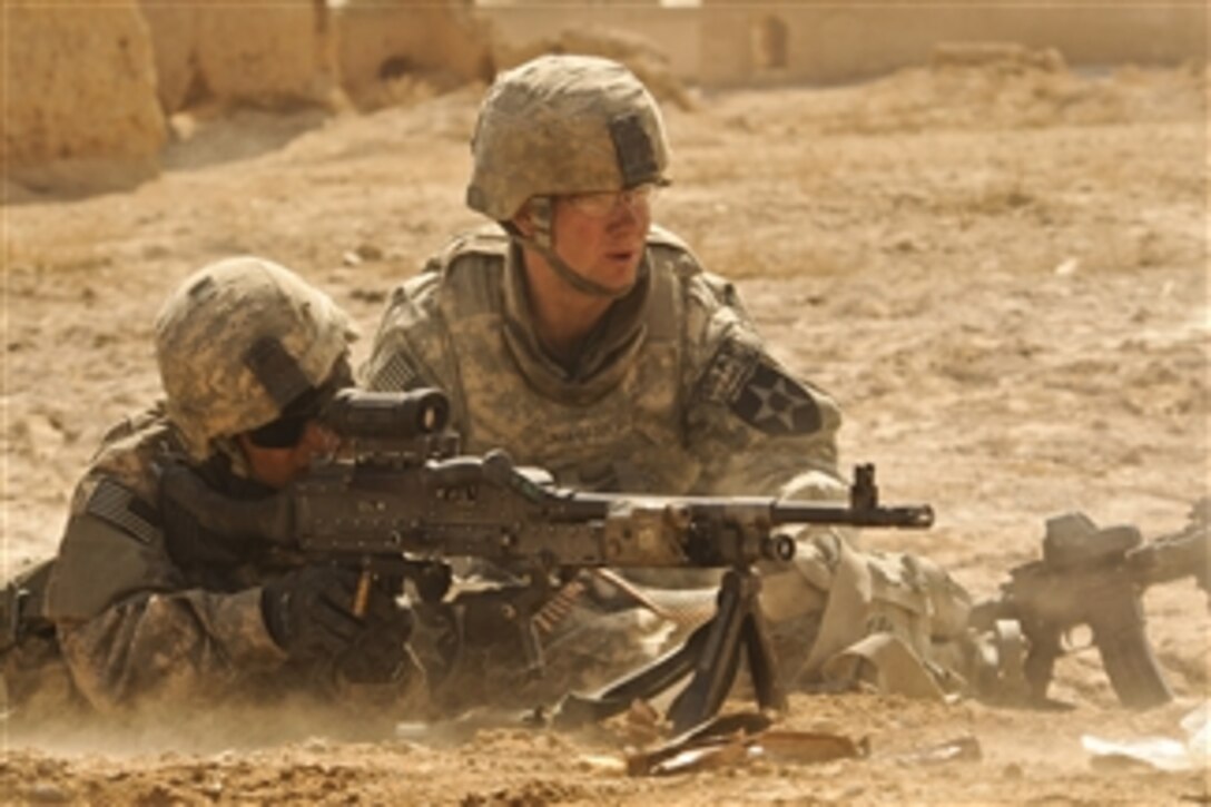 U.S. Army Spcs. Sergio Gonzales (left) and Steven Baker, both with Alpha Company, 1st Battalion, 17th Infantry Regiment, engage enemy forces during Operation Moshtarak in Badula Qulp, Helmand province, Afghanistan, on Feb. 19, 2010.  