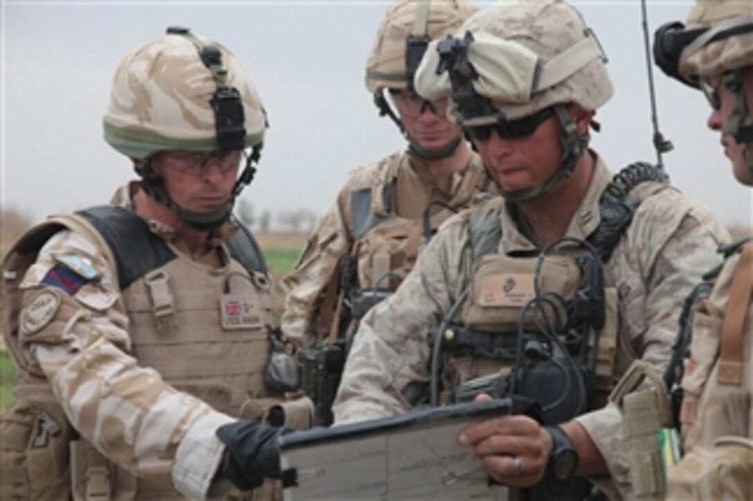 U.S. Marine Corps Capt. Stephan P. Karabin II (right) with Charlie Company, 1st Battalion, 3rd Marine Regiment talks with British soldiers about clearing roads near Marjah, Afghanistan, on Feb. 21, 2010.  Karabin is working with many different Task Force Helmand units to remove all Taliban forces from the province.  