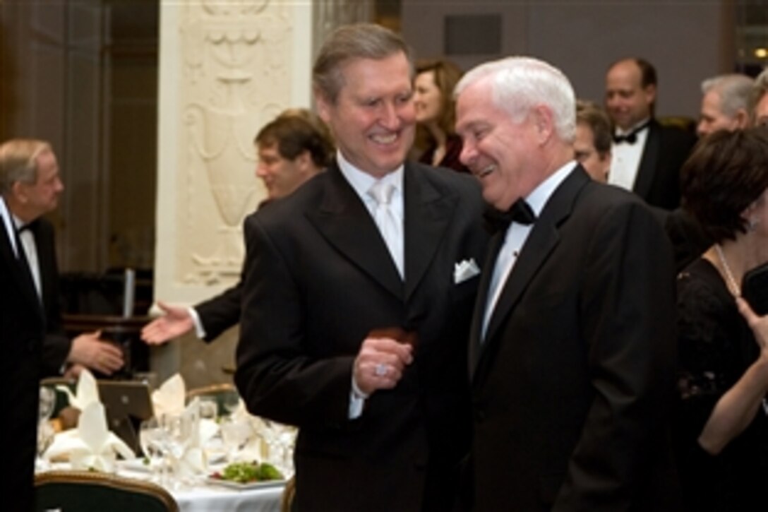 Former Defense Secretary William S. Cohen, left, shares a laugh with Defense Secretary Robert M. Gates before the start of the Nixon Center Distinguished Service Award dinner honoring Gates in Washington, D.C., Feb. 24, 2010.  