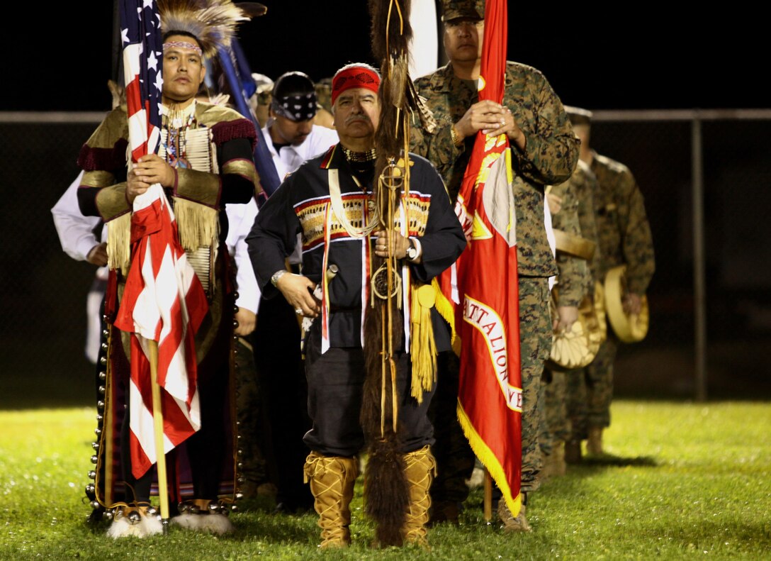 John David Gomez (center), former Marine Vietnam veteran and descendant of the Apache, Yaqui and Mexican people, carries the sacred American Indian Eagle Staff during “Operation One Drum’s” closing ceremony at Camp Pendleton, Feb. 25. American Indians from across the nation embraced nearly 30 combat veterans during a four-day workshop designed to alleviate combat stress.