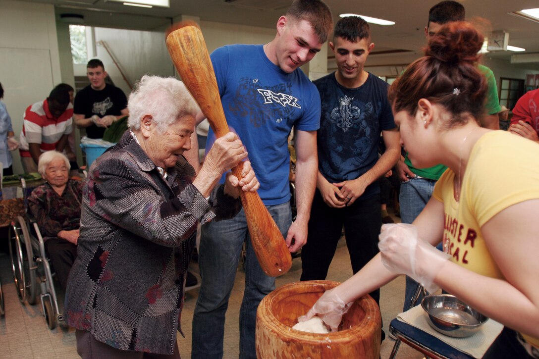 Nobuko Igei, 92, a resident of the Hikaraga Nursing Home shows Marines with 7th Communication Bn., III Marine Expeditionary Force Headquarters Group, III MEF, how to make traditional “mochi” or Japanese rice cake, during their visit, Feb. 26, at the Hikaraga Nursing Home.