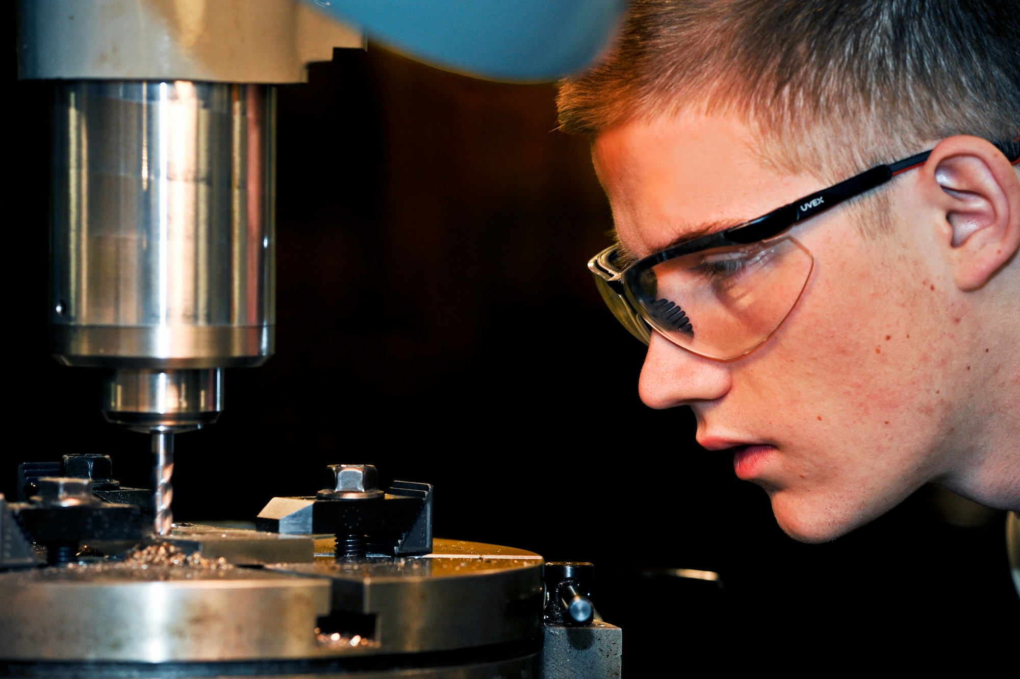 ELMENDORF AIR FORCE BASE, Alaska – Airman 1st Class Derek Johnson, 3rd Equipment Maintenance Squadron, machines a pad for a crew step here Feb. 11. (Air Force photo/ Airman 1st Class Jack Sanders)