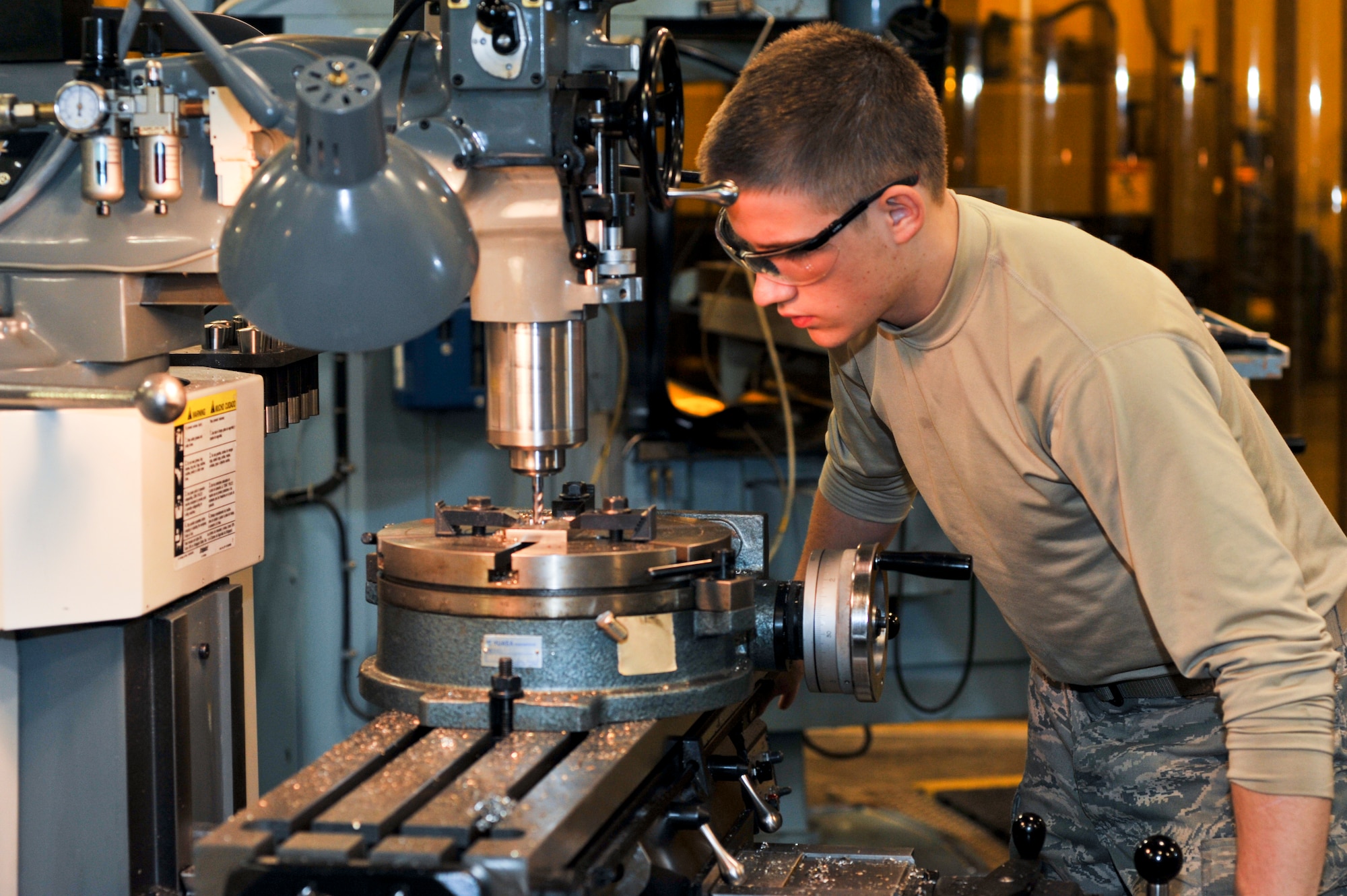 ELMENDORF AIR FORCE BASE, Alaska – Airman 1st Class Derek Johnson, 3rd Equipment Maintenance Squadron, machines a pad for a crew step here Feb. 11. (Air Force photo/ Airman 1st Class Jack Sanders)