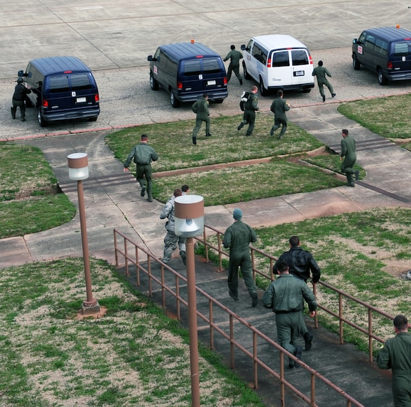 BARKSDALE AIR FORCE BASE, La. - Pilots rush to their vans after the emergency siren goes off during the Nuclear Operational Readiness Exercise here Feb 25. The exercise tested the 2d Bomb Wing’s operations planning and ability to generate a large number of B-52s to support the global strike mission. (U.S. Air Force photo by Senior Airman La’Shanette V. Garrett) (RELEASED)
