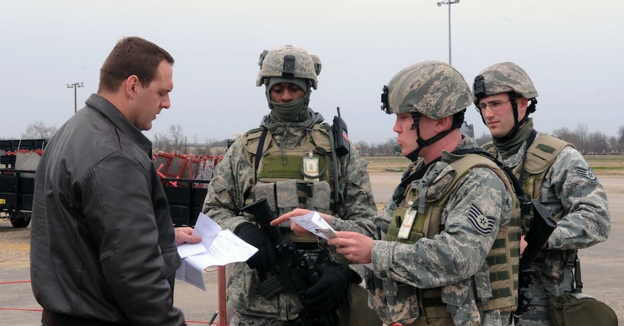 BARKSDALE AIR FORCE BASE, La. - Members of the 2d Security Forces Squadron review paperwork with a pilot during the Nuclear Operational Readiness Exercise here Feb 25. The exercise tested the 2d Bomb Wing’s operations planning and ability to generate a large number of B-52s to support the global strike mission. (U.S. Air Force photo by Senior Airman La’Shanette V. Garrett) (RELEASED)