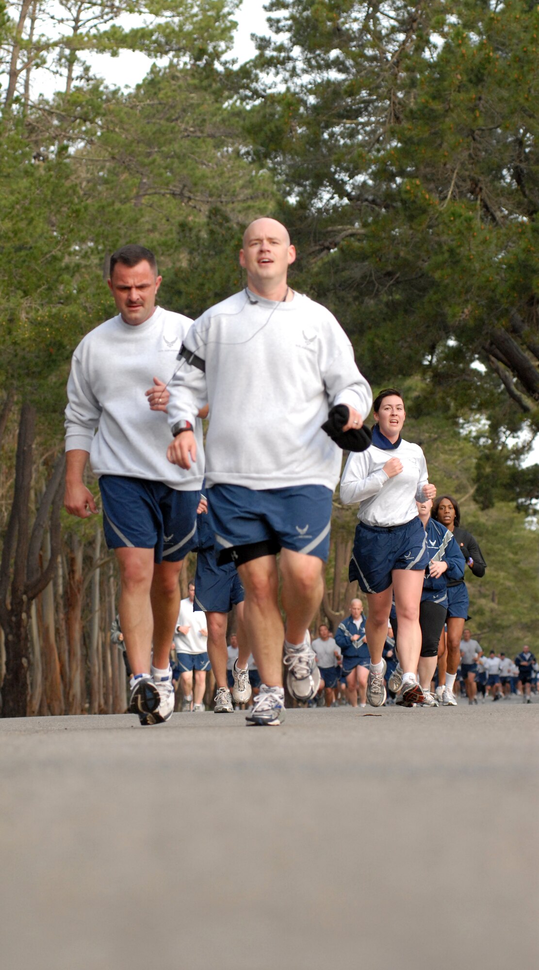 VANDENBERG AIR FORCE BASE, Calif. -- While the sun rises to light up the roads, runners participating in Vandenberg’s Fit-to-Fight Run pass by the fitness center here Friday, Feb. 26, 2010. The run consists of three long stretches of paved road that combine to make the run approximately three miles. (U.S. Air Force photo/Airman 1st Class Angelina Drake)
