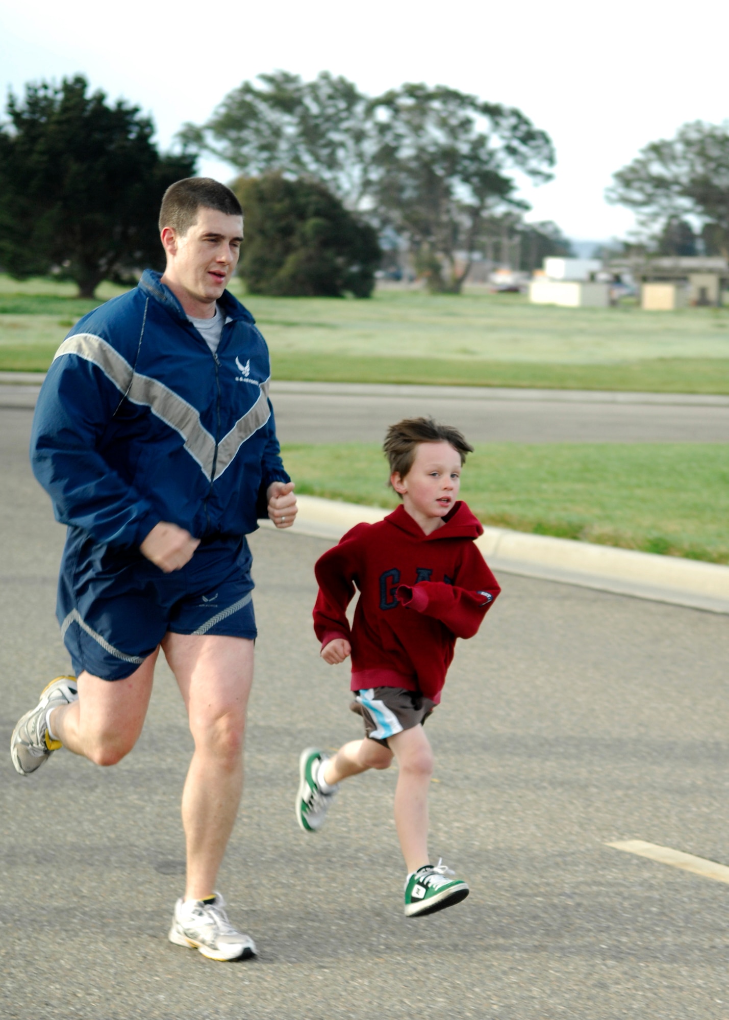 VANDENBERG AIR FORCE BASE, Calif. --Starting out young, a boy completes the Fit-to-Fight Run alongside an Airman here Feb. 26, 2010. The 5K run is held monthly and shows Team V’s commitment to fitness.(U.S. Air Force photo/Airman 1st Class Heather Shaw)
