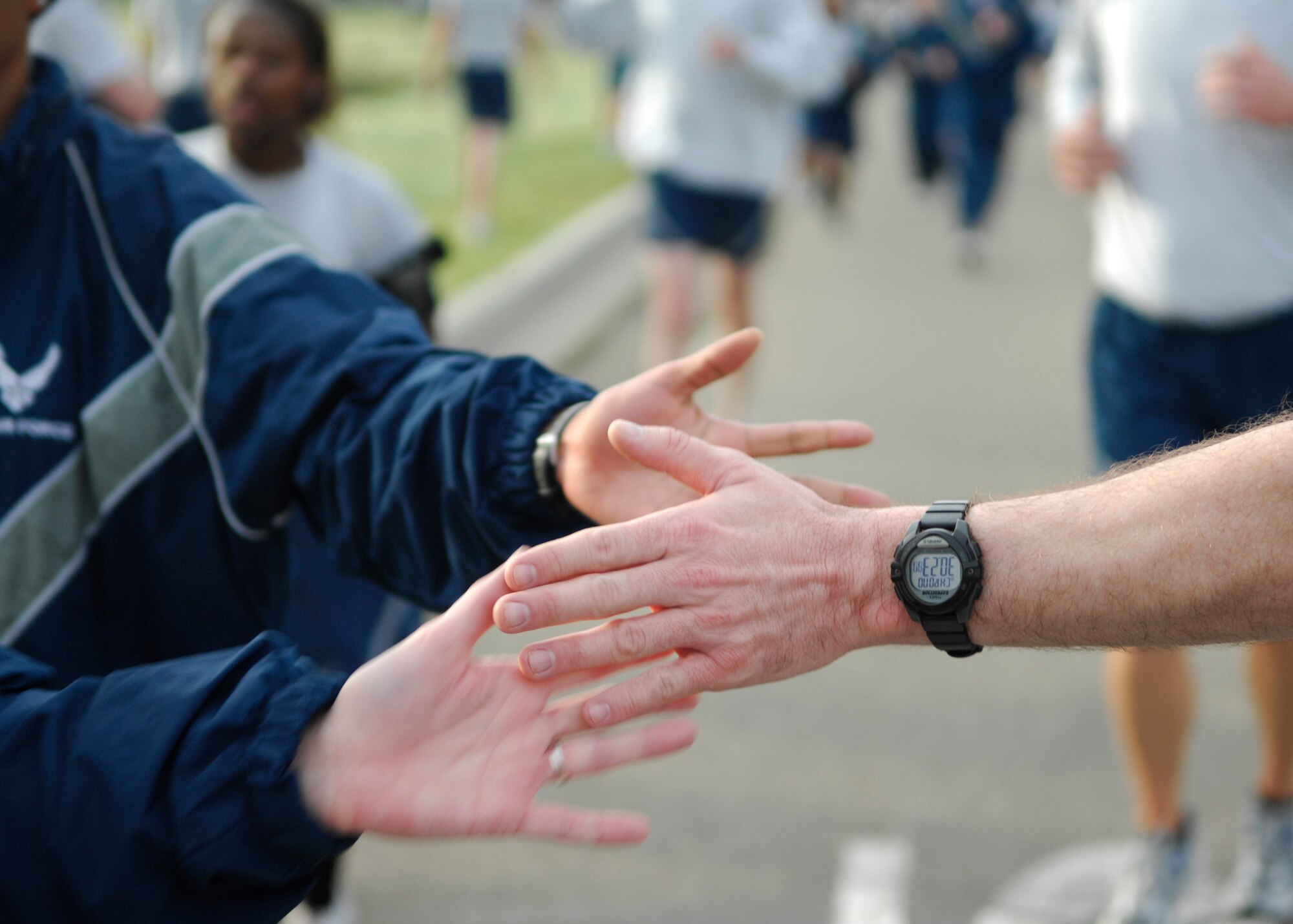 VANDENBERG AIR FORCE BASE, Calif. --Signifying the end of the run, Airmen receive a high-five at the Fit-to-Fight Run finish line here Feb. 26, 2010. Members of Team V participate in a 5K run monthly in an effort to exemplify the “Fit to Fight” standard. (U.S. Air Force photo/Airman 1st Class Heather Shaw)