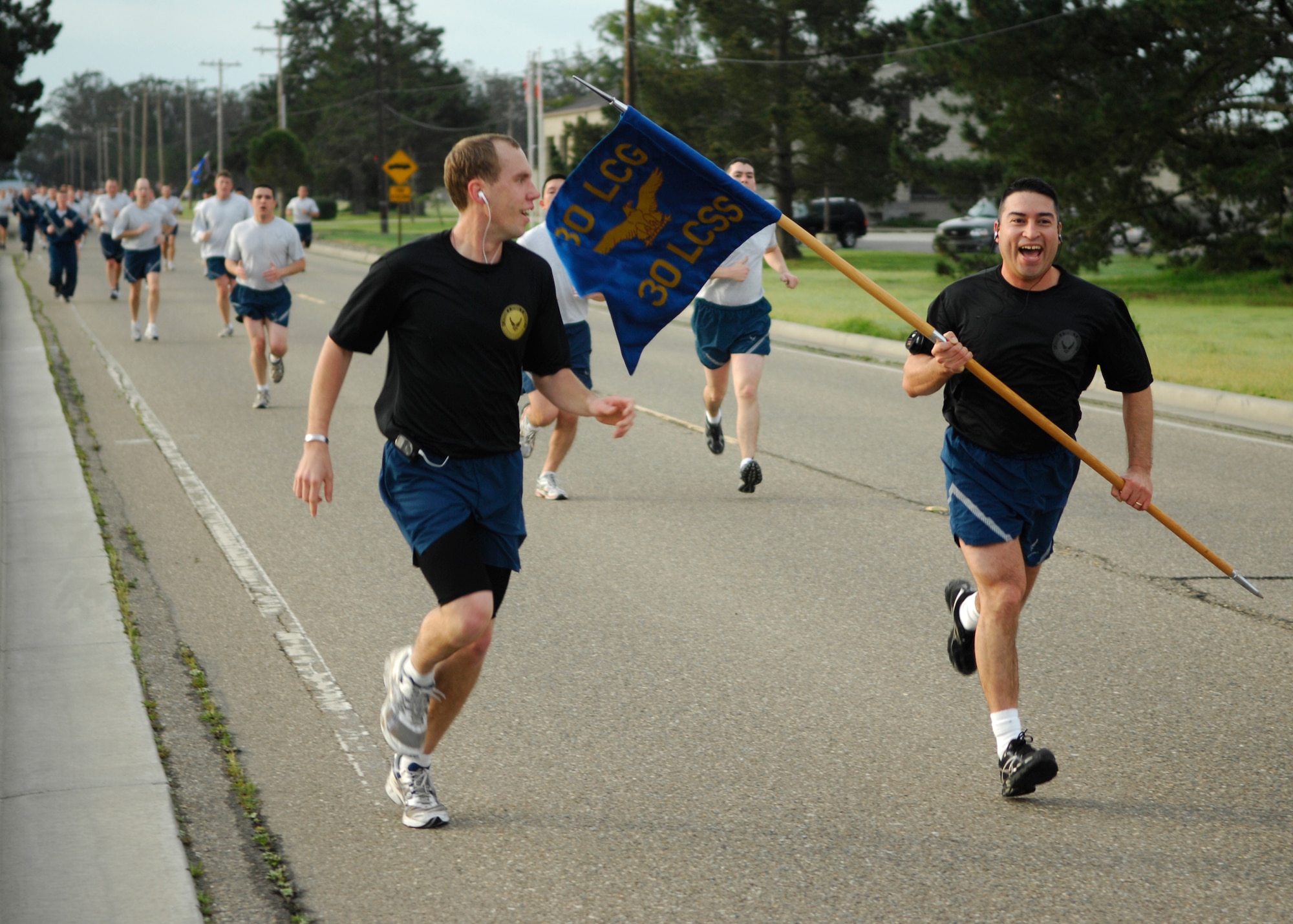 VANDENBERG AIR FORCE BASE, Calif. --Rooting each other on, Airmen from the 30th Launch Control Group race to the finish line during the Fit-to-Fight Run here Feb. 26, 2010. The black shirts show that the Airmen excelled during their physical training test and received more than a 90 percent.(U.S. Air Force photo/Airman 1st Class Heather Shaw)