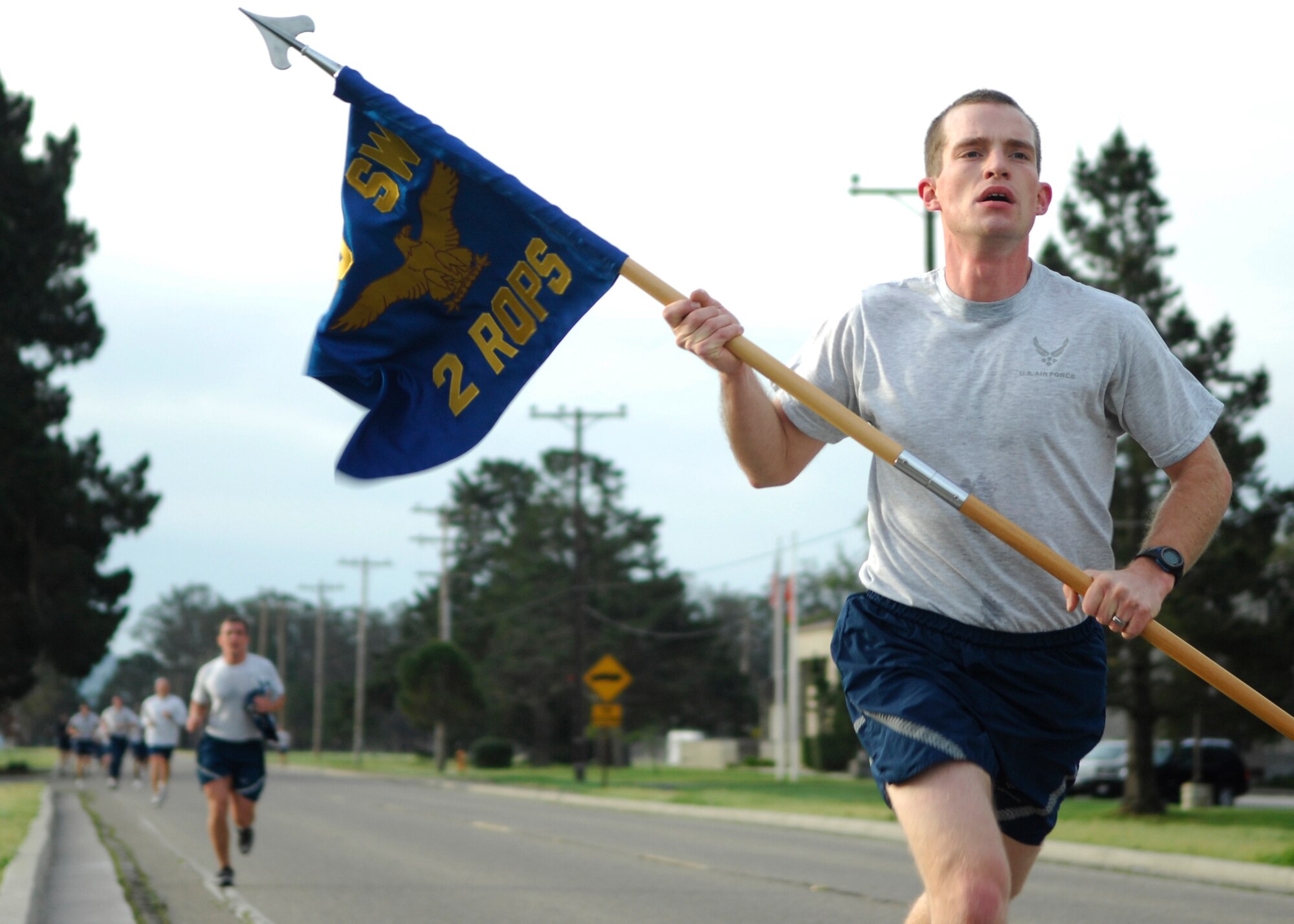 VANDENBERG AIR FORCE BASE, Calif. -- With his eyes focused ahead, an Airman from the 2nd Range Operation Squadron carries the guidon toward the finish line during the Fit-to-Fight Run here Feb. 26, 2010. Various Airmen have the privilege of carrying the guidon and representing their squadron.(U.S. Air Force photo/Airman 1st Class Heather Shaw)
