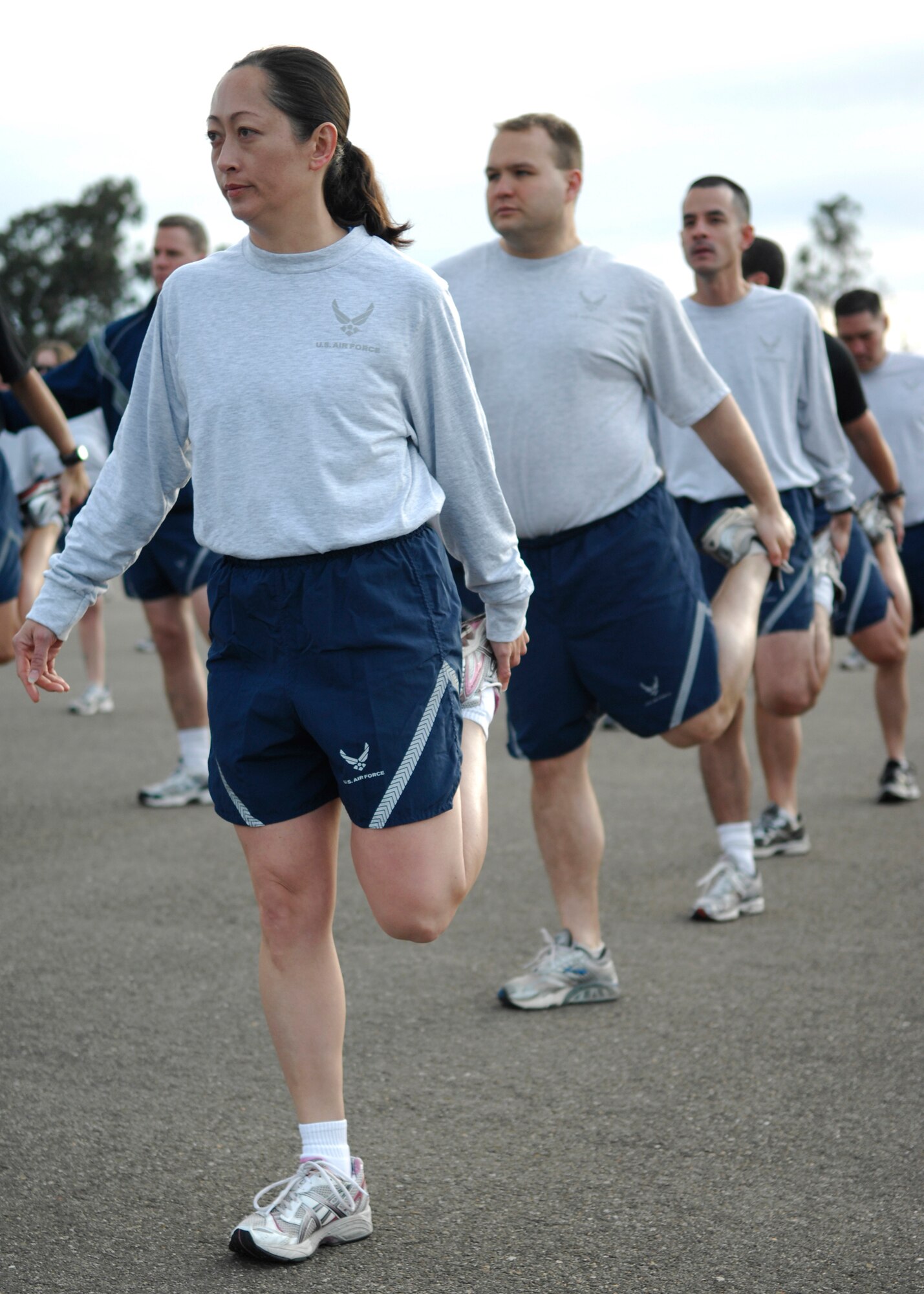 VANDENBERG AIR FORCE BASE, Calif. -- Ensuring that their muscles are ready for running, members of Team V participate in group stretching prior to the Fit-to-Fight Run here Feb. 26, 2010. Airmen of the 30th Space Wing run together every month showing their dedication to fitness.(U.S. Air Force photo/Airman 1st Class Heather Shaw)