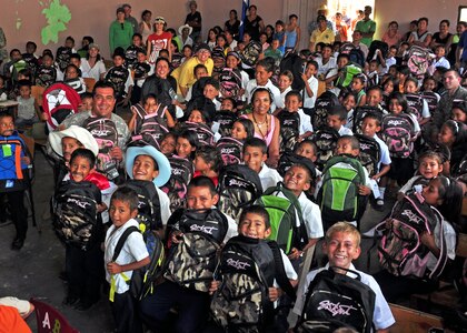 Honduran children show off their new backpacks that were passed out in rural areas of Honduras by members of Soto Cano Air Base, Honduras in conjunction with the Give a Kid a Backpack organization Feb. 24. More than 1,000 backpacks were passed out from Feb. 23-26. (U.S. Air Force Photo/Staff Sgt. Bryan Franks)