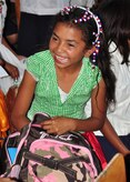 A Honduran child smiles after receiving one of more than 1,000 backpacks that were passed out in rural areas of Honduras by members of Soto Cano Air Base, Honduras in conjunction with the Give a Kid a Backpack organization Feb. 24. Give a Kid a Backpack is a nonprofit organization that works towards enriching the lives of impoverished children around the world with backpacks filled with school supplies through the partnership with other nonprofit organizations. (U.S. Air Force Photo/Staff Sgt. Bryan Franks)