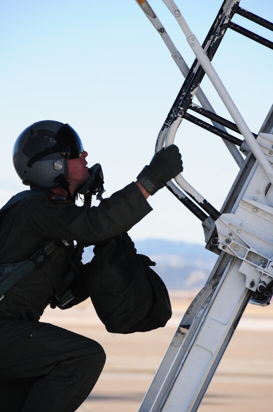 ELLSWORTH AIR FORCE BASE, S.D. -- Capt. Patrick Mullen, 37th Bomb Squadron pilot, climbs up the ladder of a B-1B Lancer before take off, Feb. 26.  Col. Kory Cornum, Air Combat Command's command surgeon, flew in the bomber and visited Ellsworth to recognize top medical performers. (U.S. Air Force photo/Airman 1st Class Anthony Sanchelli)
