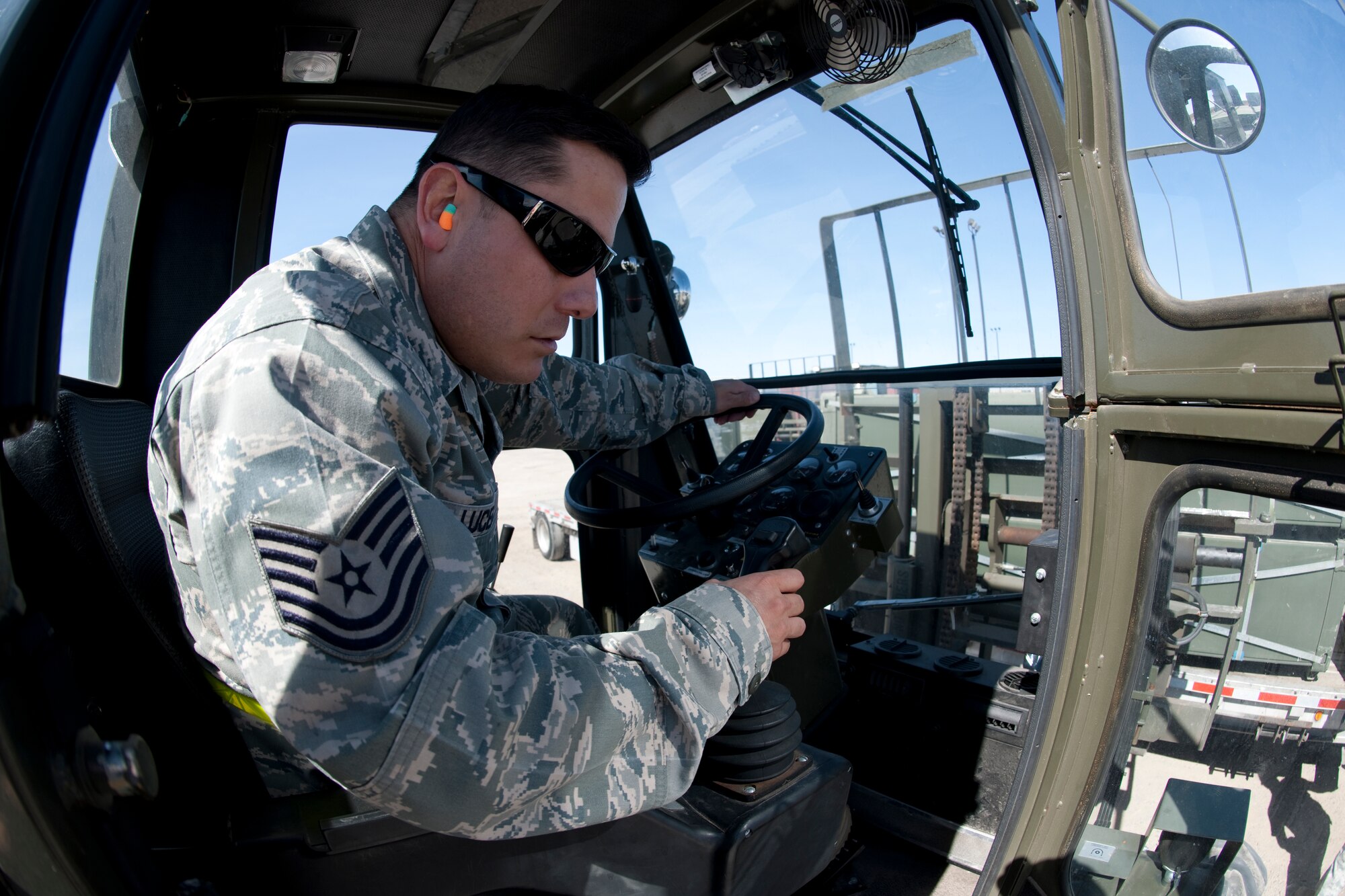 HOLLOMAN, AIR FORCE BASE, N.M. -- Tech. Sgt. Raymond Lucero, a team leader with the 49th Materiel Maintenance Support Squadron, uses a 13,000 pound loader to load nearly 11,000 pounds of AM-2 matting onto a flatbed trailer on Feb. 24.  The 49th MMSS is deploying 480,000 square-feet of the matting that will be assembled to create airstrips supporting joint and coalition forces throughout Afghanistan. (U.S. Air Force photo by Staff Sgt. Joe Laws) (Released)