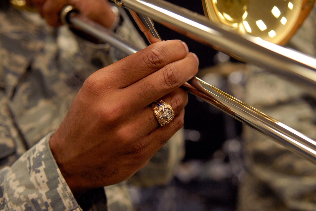 Trombone player, Tech. Sgt. Michael Hornbuckle, practicing during band warm ups, Hickam Air Force Base, Hawaii, Feb. 23, 2010.  Sergeant Michael?s identical twin brother, trumpet player, Tech. Sgt. Brian Hornbuckle, recently joined as a member of the Band of the Pacific. This is the twins second time being assigned together since leaving home and joining the Air Force together.  Sergeant Brian?s arrival makes them the only pair of identical twins to performing in an Air Force band together. (U.S. Air Force photo/Tech. Sgt Jerome S. Tayborn)     