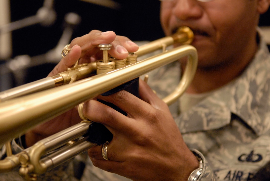 Trumpet player, Tech. Sgt. Brian Hornbuckle, practicing during band warm ups, Hickam Air Force Base, Hawaii, Feb. 23, 2010. Sergeant Brian recently joined his identical twin brother, trombone player, Tech. Sgt. Michael Hornbuckle, as a member of the Band of the Pacific. This is the twins second time being assigned together since leaving home and joining the Air Force together.  Sergeant Brian?s arrival makes them the only pair of identical twins to performing in an Air Force band together. (U.S. Air Force photo/Tech. Sgt Jerome S. Tayborn)     
