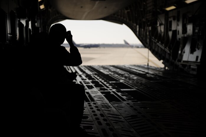 Passengers on a C-17 Globemaster III look to take pictures out the back of the aircraft as they taxi off of runway 03/21 at Joint Base Charleston, S.C., Feb. 25, 2010. The flight was the first to take off and land on runway 03/21 after a $30 million dollar reconstruction project. The runway will now have newly paved asphalt overruns and 25-foot wide asphalt-paved shoulders, both of which the runway lacked. (U.S. Air Force photo by Staff Sgt. Eric Harris/Reviewed)