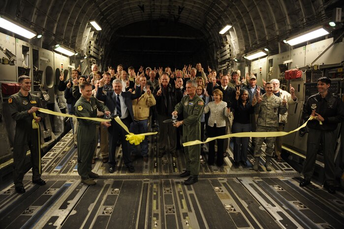 Col. John Wood, 437th Airlift Wing commander, and Col. Steven Chapman, 315th Airlift Wing commander, cut the ribbon to officially reopen runway 03/21 as they prepare for takeoff at Joint Base Charleston, S.C., Feb. 25, 2010. The flight was the first to take off and land on runway 03/21 after a reconstruction project began April 9, 2009. (U.S. Air Force photo by Staff Sgt. Eric Harris/Reviewed