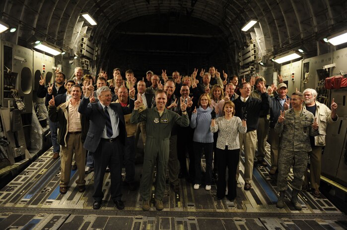 Passengers on a C-17 Globemaster III hold up the numbers two and one as they prepare for takeoff from runway 03/21 at Joint Base Charleston, S.C., Feb. 25, 2010. The flight was the first to take off and land on runway 03/21 after a $30 million dollar reconstruction project. The last major work done on Joint Base Charleston runways was in 1968. (U.S. Air Force photo by Staff Sgt. Eric Harris/Reviewed)