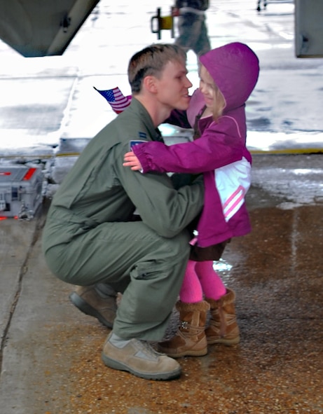 BARKSDALE AIR FORCE BASE, La. – Capt. Aaron Woodward, 20th Bomb Squadron, is greeted by his daughter, Ella, 5, after his return from a recent deployment to Andersen Air Force Base, Guam in support of the continuous bomber presence mission on Feb. 26. (U.S. Air Force photo by Senior Airman Alexandra M. Longfellow) (RELEASED)
