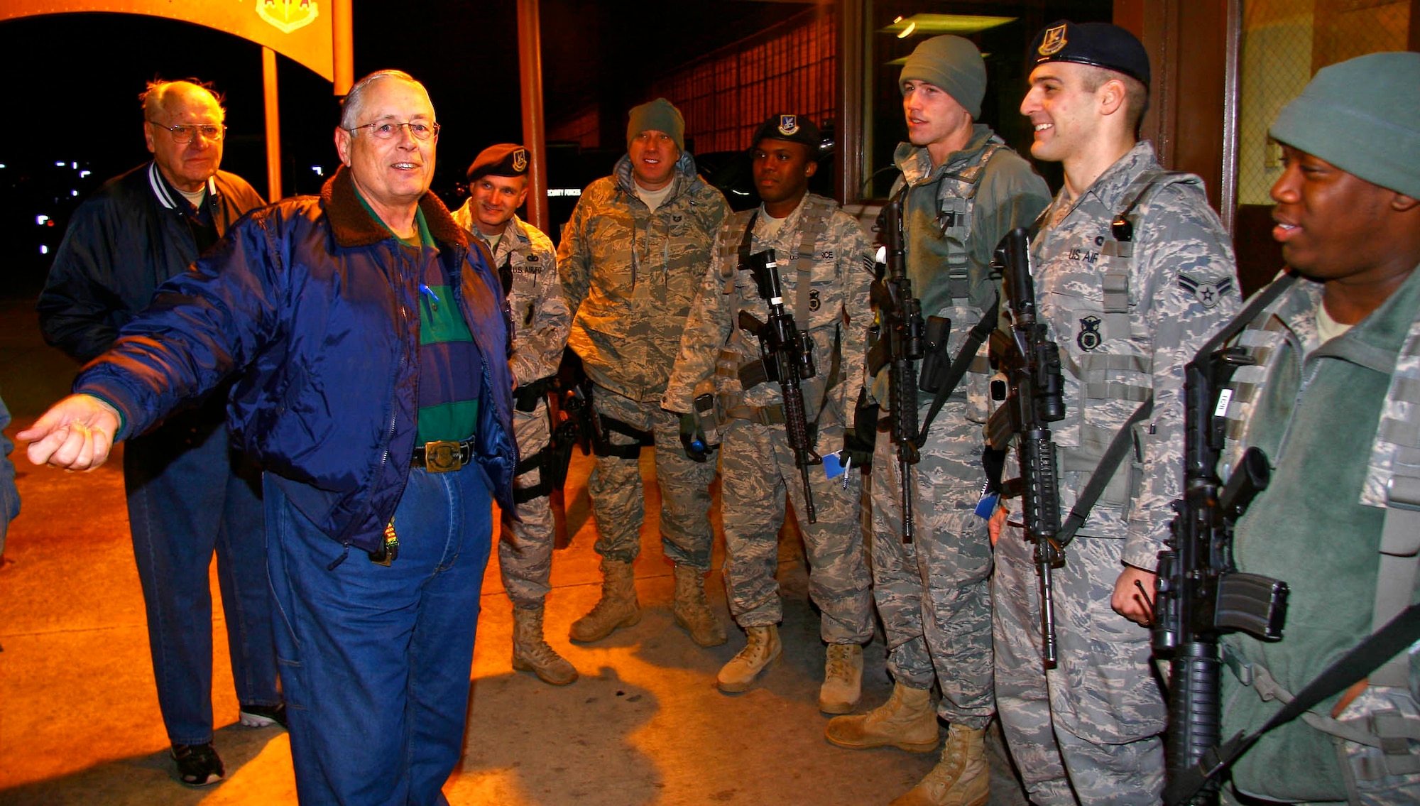 Retired Senior Master Sgt. William “Pete” Piazza, center, a former Air Force Security Forces member, makes a midnight visit to Tinker Airmen safeguarding the base. Sergeant Piazza and other former cops want the Airmen to know they are not alone.(Air Force photo by John Stuart)
