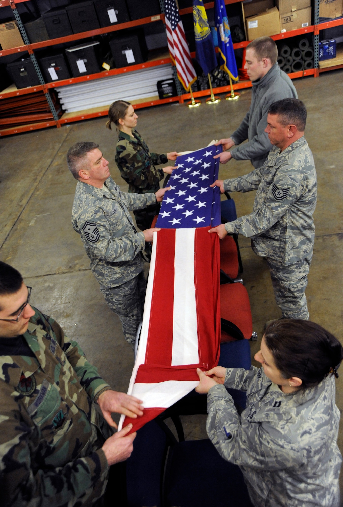 Oregon Air National Guardsmen practice folding a flag during 4 days of Honor Guard training at the Portland Air Naional Guard Base on February 24th, 2010.  (U.S. Air Force photograph by SSgt John Hughel, 142nd Fighter Wing Public Affairs)