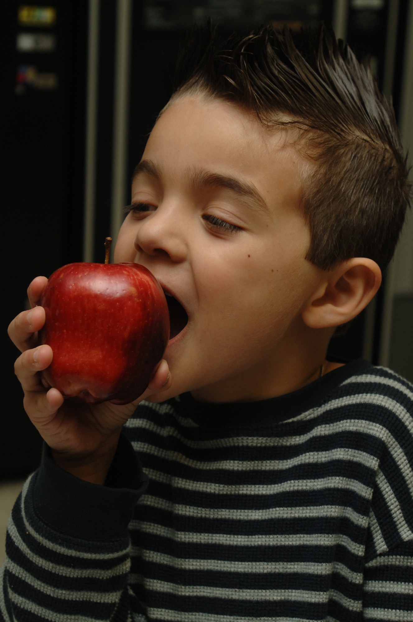 Seven-year-old Angel Cuevas enjoys an apple at Wilford Hall Medical Center Feb. 25.  Angel is the son of Spc. Ana Cuevas, assigned to the Institute of Surgical Research, Ft. Sam Houston, Texas. (Air Force photo by Senior Airman Nicole Roberts)  