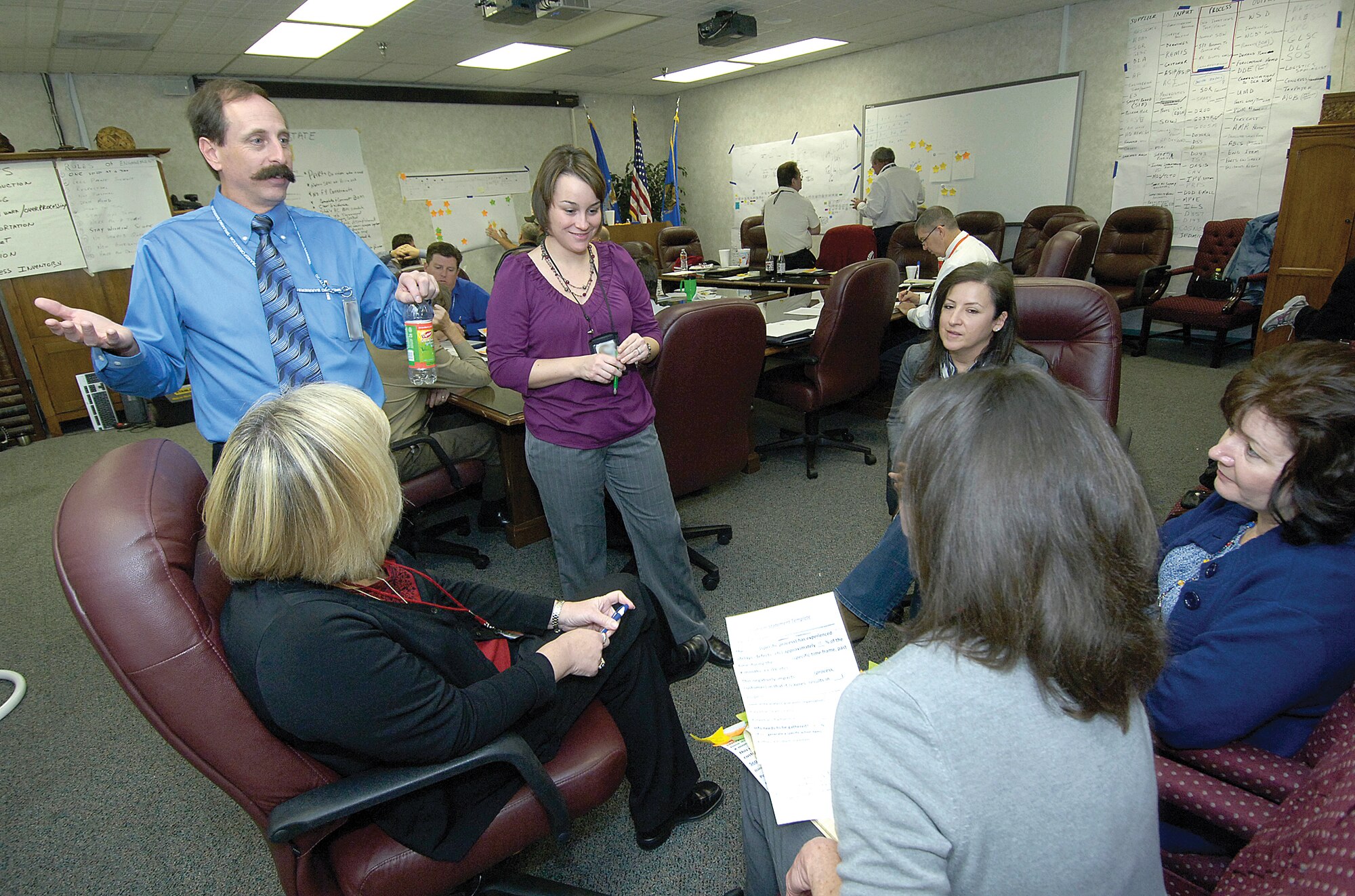 During a recent week-long enterprise value stream mapping and analysis session at Tinker, lead facilitator Brian deFonteny energetically moves between groups, encouraging team members to continue looking for new ways to improve processes.(Air Force photo by Margo Wright)