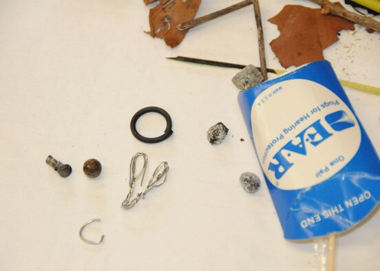 Close up photo displays a sample of potentially aircraft-damaging debris collected from the Duke Field flightline Feb. 23 during a foreign object damage prevention “FOD walk” by 919th Special Operations Wing reservists. While aircraft maintenance crews routinely conduct “FOD walks,”  this event,  directed by the wing commander, brought wide participation from Duke Field members representing a variety of non-maintenance Air Force specialties.  (U.S. Air Force photo/Staff Sgt. Jon McCallum)
