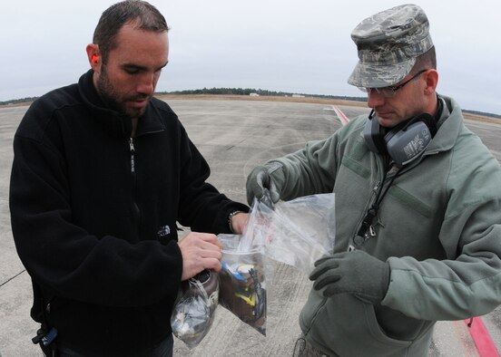Technical Sgt. Jon Lukowski, 919th Maintenance Squadron , left, and Master Sgt. Marion Lollis, 919th Maintenance Group,  squadron and wing foreign object damage prevention monitors, respectively, gather up bags of potentially aircraft-damaging debris collected by participants in the Feb. 23 “FOD walk” on the Duke Field flightline. 
While aircraft maintenance crews routinely conduct “FOD walks,”  this event,  directed by the wing commander, brought wide participation from Duke Field members representing a variety of non-maintenance Air Force specialties.  (U.S. Air Force photo/Staff Sgt. Jon McCallum)