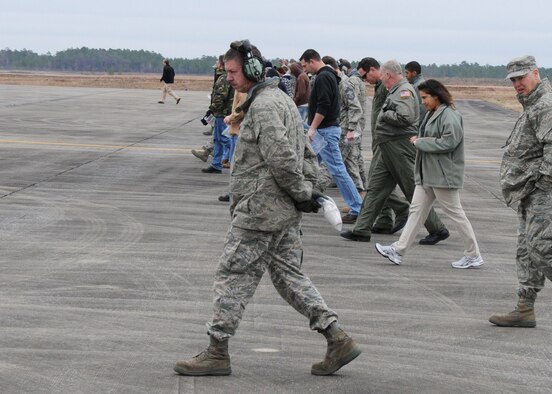 Dozens of 919th Special Operations Wing reservists walk the Duke Field flightline Feb. 23 to find and remove debris that could potentially cause foreign object damage, better known as FOD, to operating aircraft engines.   While aircraft maintenance crews routinely conduct “FOD walks,”  this event,  directed by the wing commander, brought wide participation from Duke Field members representing a variety of non-maintenance Air Force specialties.  (U.S. Air Force photo/Staff Sgt.  Jon McCallum)