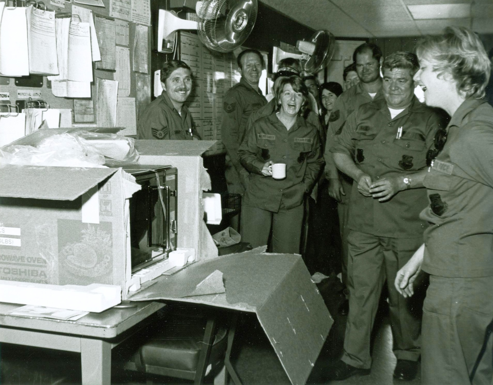 Fellow unit members present a microwave oven to then Staff Sgt. Brenda West in 1983. West’s coworkers, trying to lift her spirits after her mother passed away, gathered money for flowers and raised enough to purchase the new oven instead. (Courtesy photo)
