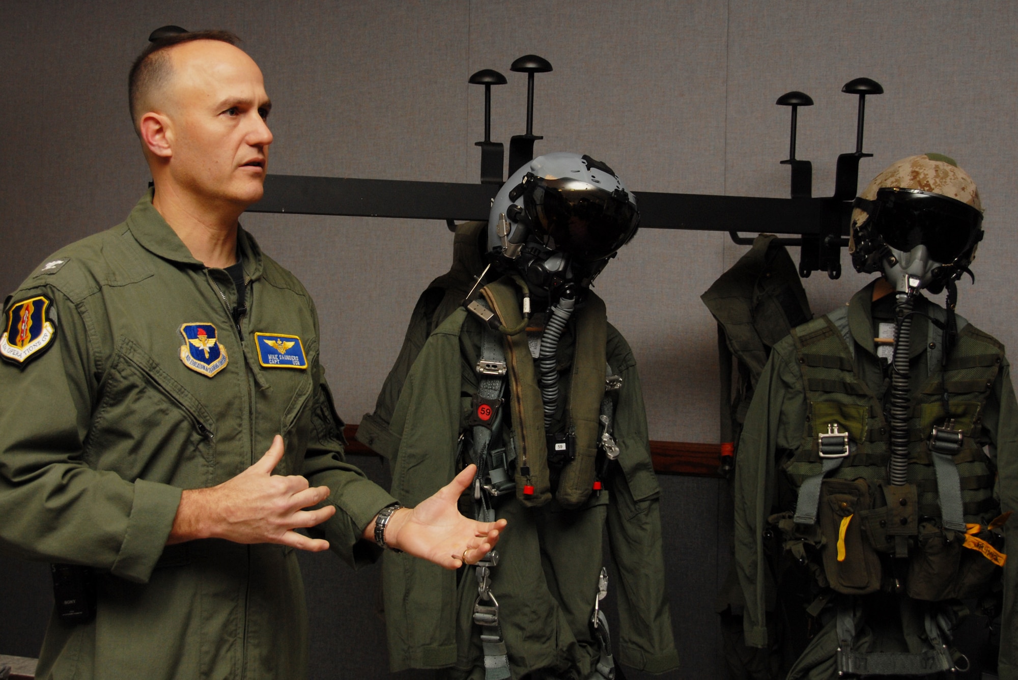 EGLIN AIR FORCE BASE, Fla. – Navy Capt. Mike Saunders, 33rd Operations Group deputy commander, describes the F-35 Joint Strike Fighter pilot equipment after getting measured for the new flight suit. The new pilot equipment includes everything from underwear to cold weather outer gear to anti-G garments. The measurement brought Eglin one step closer to being able to commence training, said Marine Col. Arthur Tomassetti, 33rd Fighter Wing commander. (U.S. Air Force photo/ Airman 1st Class Anthony Jennings)