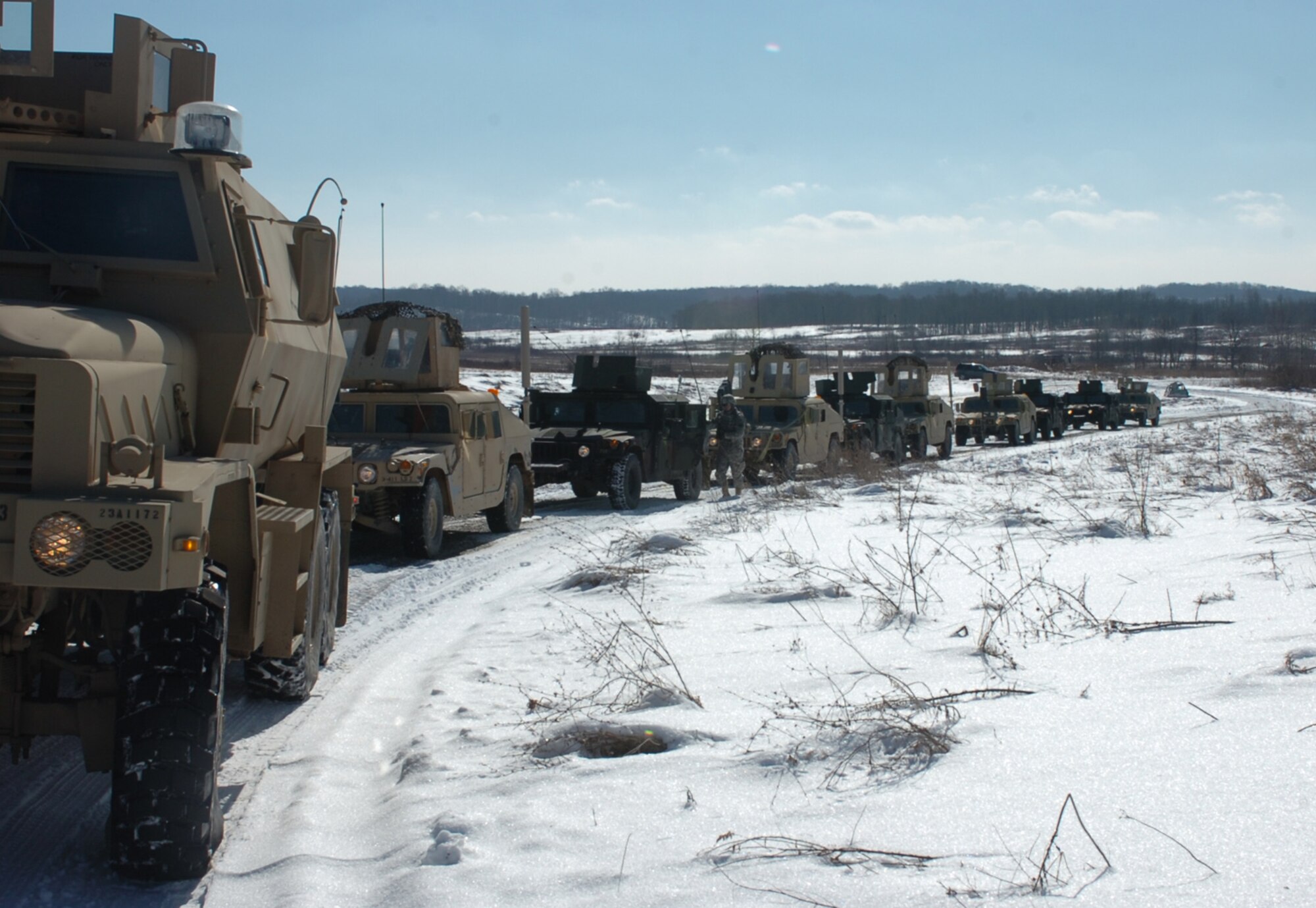 A convoy of vehicles from the Arkansas Agriculture Development Team prepares to move out on a convoy exercise along the snow covered roads of Camp Atterbury, Ind. The cold winter temperatures and nearly daily snows challenged the team of Arkansans to get acclimatized quickly. The team still has  additional training at the post in central Indiana before deploying to Afghanistan in March. Three 188th Fighter Wing members will deploy with the ADT.  (Photo by Lt. Col. Keith Moore/Arkansas ADT Public Affairs Officer) 