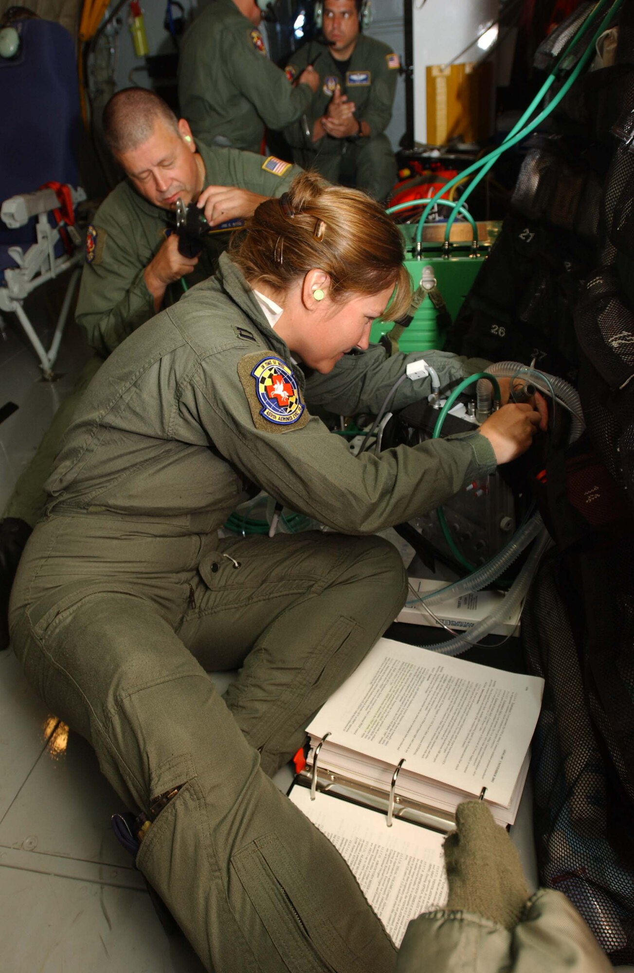 Maj. Heather Everly, flight nurse, 459th Aeromedical Squadron on an air evacuation training mission on a KC-135R Stratotanker. Staff Sgt. Joe Byrd and Maj. Everly, 459th AES, provide medical equipment training during an Aeromedical Readiness training mission (courtesy photo).