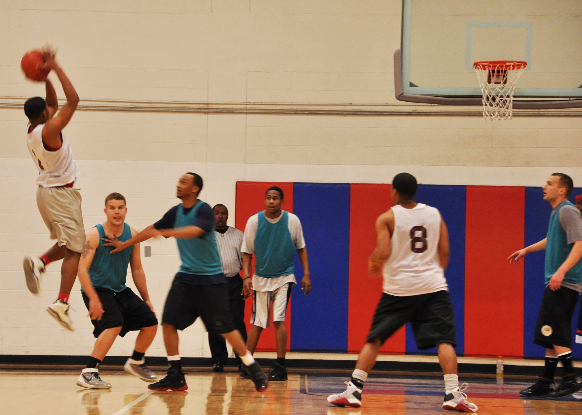 EGLIN AIR FORCE BASE, Fla. --  A player from the 96th Force Support Squadron, 1-5, shoots a field goal over members of the 1st Special Operations Maintenance Squadron, 7-1, during an intramural basketball game at the Eglin Fitness Center, Feb. 25. The 1st SOMXS team came out victorious with a 53-43 win. Playoffs are scheduled to begin March 8, where the top 18 teams will compete in double elimination games to be crowned intramural basketball champions. (U.S. Air Force photo/ Airman 1st Class Anthony Jennings)