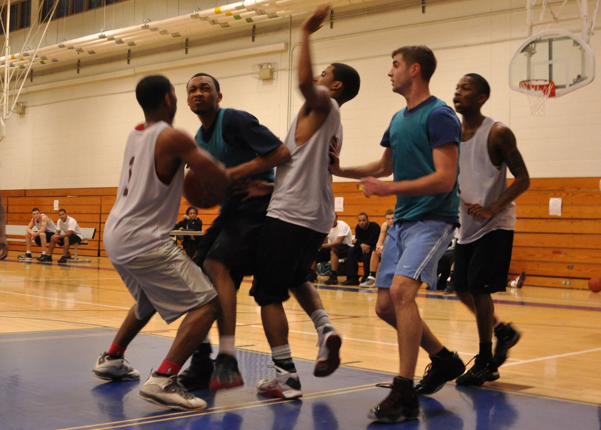 EGLIN AIR FORCE BASE, Fla. –  A 1st Special Operations Maintenance Squadron player, 7-1, drop steps for a layup through a cluster of 96th Force Support Squadron players, 1-5, during an intramural basketball game at the Eglin Fitness Center, Feb. 25. The 1st SOMXS team came out victorious with a 53-43 win. Playoffs are scheduled to begin March 8, where the top 18 teams will compete in double elimination games to be crowned intramural basketball champions. (U.S. Air Force photo/ Airman 1st Class Anthony Jennings)