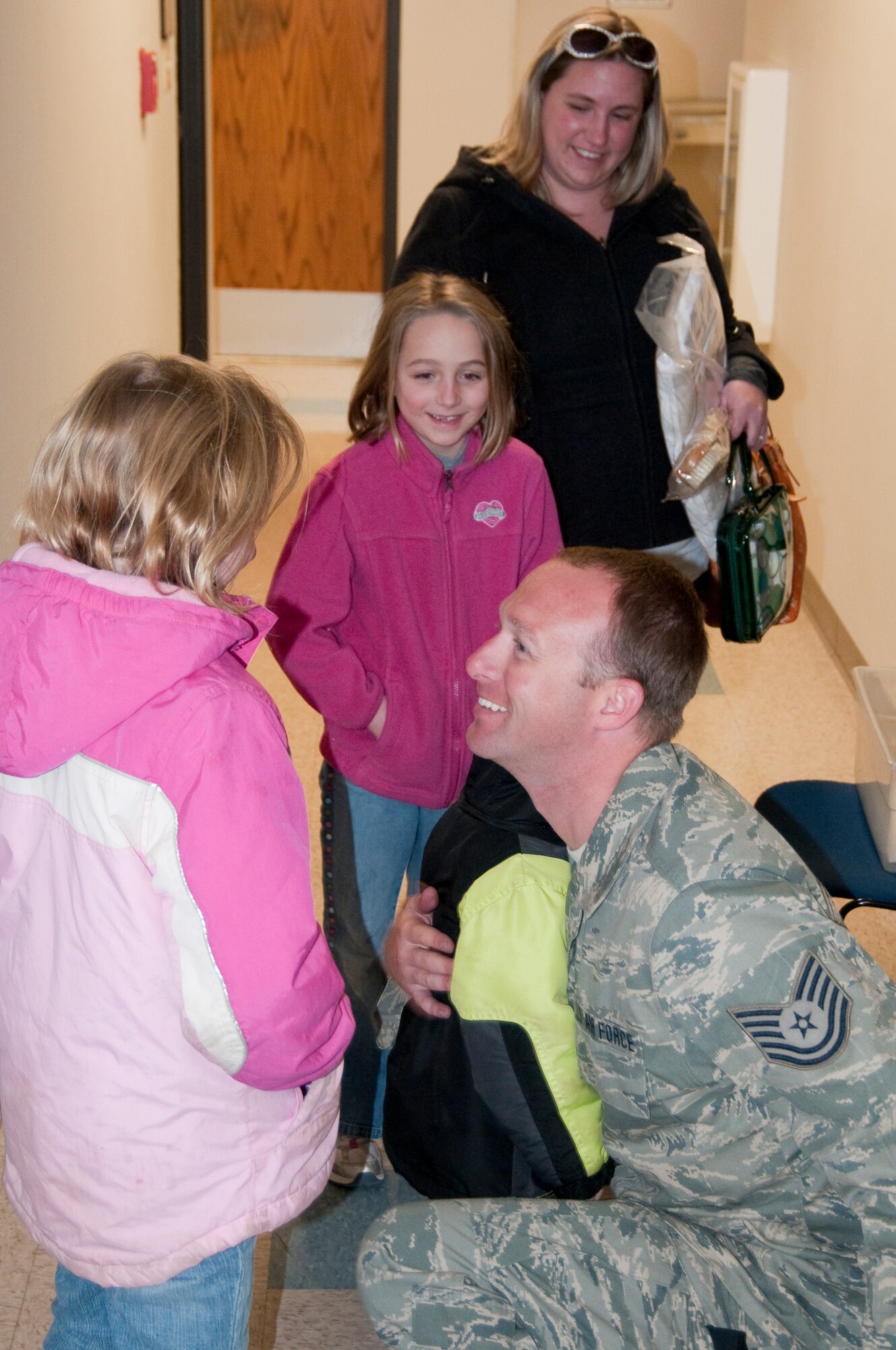 Tech. Sgt. Michael Skeens of the Kentucky Air National Guard's 123rd Contingency Response Group is welcomed home by his family Feb. 26 at the Kentucky Air Guard Base in Louisville, Ky. Sergeant Skeens was returning from a five-week deployment to the Dominican Republic where he and about 45 other Kentucky Guardsmen were operating an air hub to distribute relief supplies for victims of the Jan. 12 earthquake in Haiti. (U.S. Air Force photo by Tech. Sgt. Philip Speck/Released)