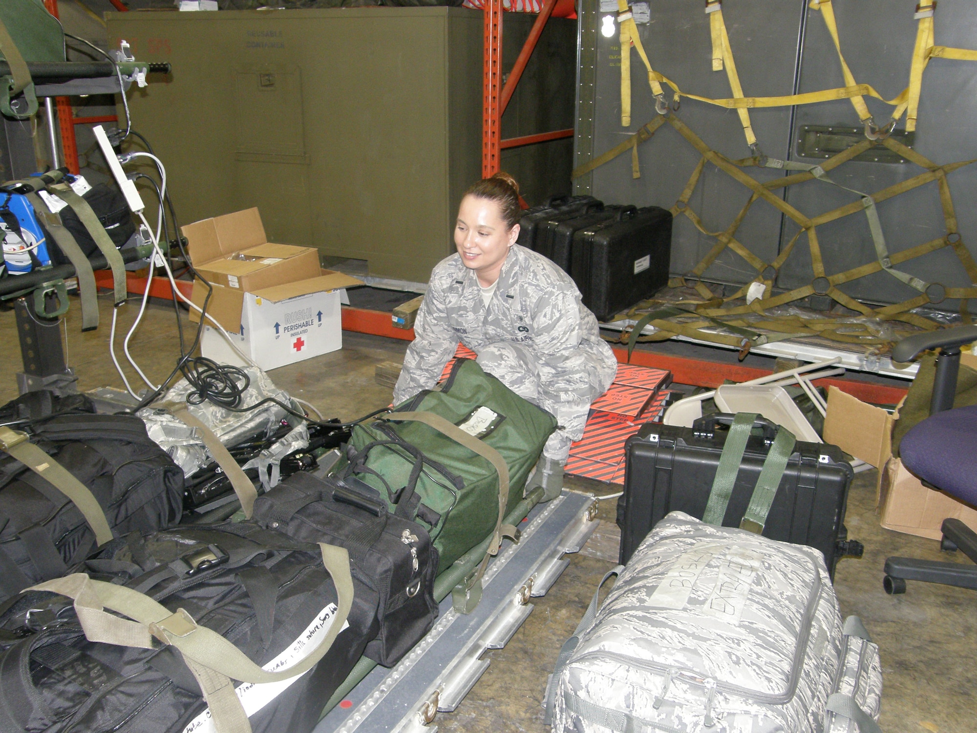 WRIGHT-PATTERSON AIR FORCE BASE, Ohio – First Lt. Shannon Simon, 445th Aeromedical Evacuation Squadron, loads equipment to be used for a future AE mission in support of Operation Unified Response. The 445th AES sent a five-person crew consisting of two flight nurses and three AE technicians; and three AE ground crew members to MacDill Air Force Base to support the on-going relief efforts in Haiti. (Courtesy photo)