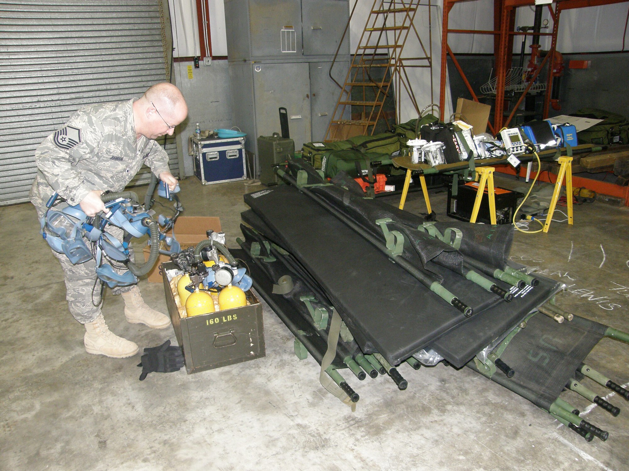 WRIGHT-PATTERSON AIR FORCE BASE, Ohio – Master Sgt. Jerry Johnson, 445th Aeromedical Evacuation Squadron, inspects equipment to be used for a future AE mission in support of Operation Unified Response. The 445th AES sent a five-person crew consisting of two flight nurses and three AE technicians; and three AE ground crew members to MacDill Air Force Base to support the on-going relief efforts in Haiti. (Courtesy photo)