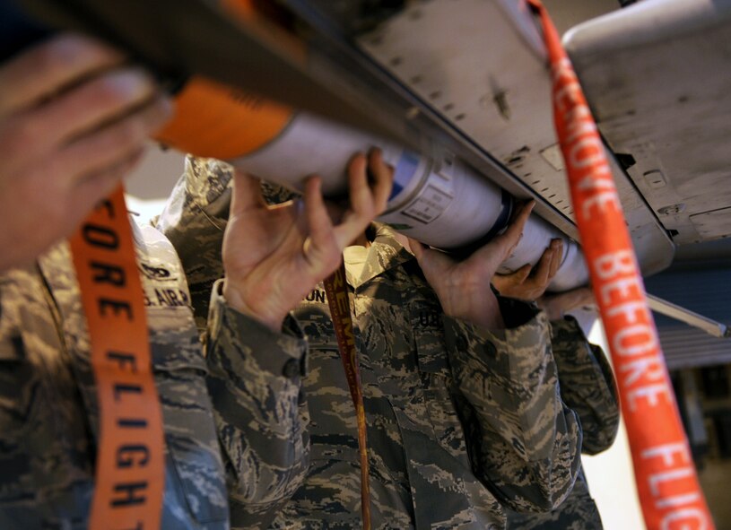 MOODY AIR FORCE BASE, Ga. -- Members of the 74th Aircraft Maintenance Unit work together to place an AIM-9 aerial intercept missile, onto an A-10C Thunderbolt II during the 2009 Annual Load Crew Competition here Feb. 12. As part of the 74th AMU’s strategy, the team loaded the missile last. (U.S. Air Force photo by Airman 1st Class Benjamin Wiseman)