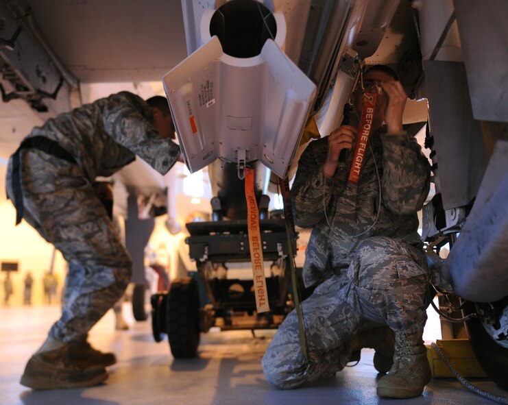 MOODY AIR FORCE BASE, Ga. -- Staff Sgt. Jeremy Nixon, 74th Aircraft Maintenance Unit weapons load crew chief, and Senior Airman Travis Van Cott, 74th AMU weapons load crew member, put the finishing touches on a loaded GB-12 laser-guided bomb during the 2009 Annual Load Crew Competition here Feb. 12. The winners of the competition will have their names and squadron inscribed on a trophy and bragging rights until next year. (U.S. Air Force photo by Airman 1st Class Benjamin Wiseman)