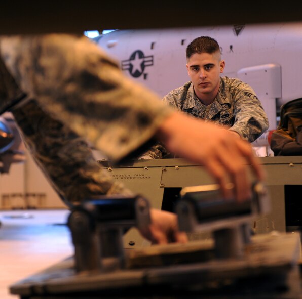 MOODY AIR FORCE BASE, Ga. -- Senior Airman Travis Van Cott, 74th Aircraft Maintenance Unit weapons load crew member, moves an MJ-1B Jammer in order to raise a GB-12 laser-guided bomb unit into position during the 2009 Annual Load Crew Competition here Feb. 12. The jammer is used to move heavy munitions into place for load. (U.S. Air Force photo by Airman 1st Class Benjamin Wiseman)