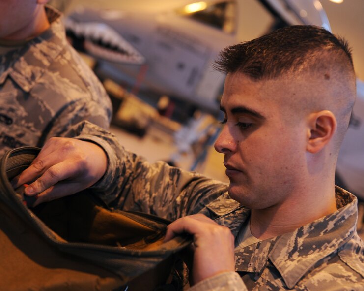 MOODY AIR FORCE BASE, Ga. -- Senior Airman Travis Van Cott, 74th Aircraft Maintenance Unit weapons load crew member, checks his tool bag before beginning the 2009 Annual Load Crew Competition here Feb. 12. Airman Van Cott did an inventory of his bag to ensure he had all the tools needed for the competition. (U.S. Air Force photo by Airman 1st Class Benjamin Wiseman)