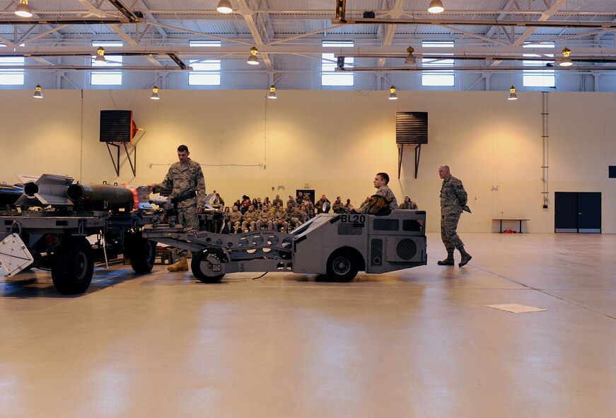 MOODY AIR FORCE BASE Ga. -- Tech Sgt. Shawn Burchfield, 75th Aircraft Maintenance Unit weapons load crew chief, spots Senior Airman Casey Allen, 75th AMU load crew member, as he lifts a laser-guided bomb off a rack during the 2009 Annual Load Crew Competition here Feb. 12. Airmen from the 74th and 75th AMUs competed to load various munitions onto an A-10C Thunderbolt II within 45 minutes. (U.S. Air Force photo by Airman 1st Class Joshua Green)