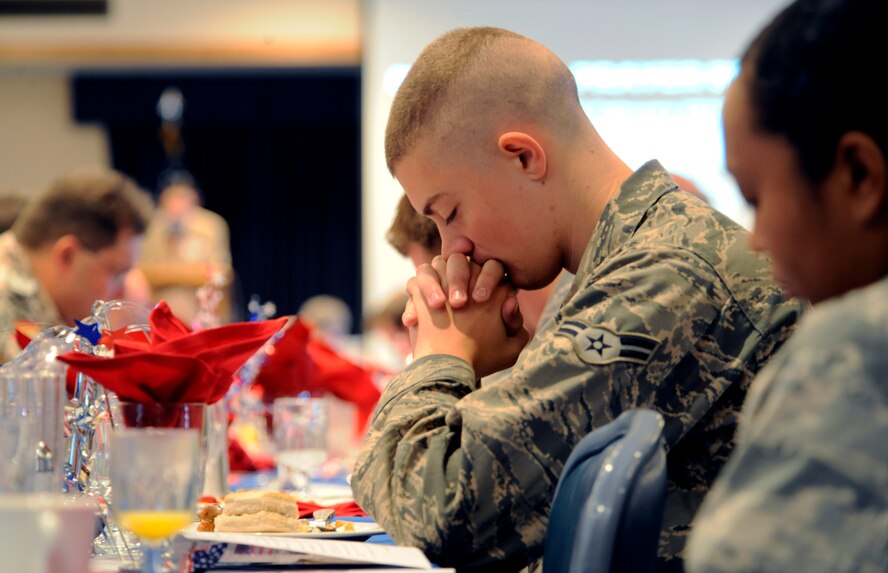 HOLLOMAN AIR FORCE BASE, N.M. -- Airmen bow their heads in prayer during the National Prayer Breakfast at the Desert Sands enlisted club, Feb. 25. The National Prayer Breakfast started back in 1942 during World War II and continues today as a way to talk about our spiritual needs and pray for members serving the country. The annual prayer breakfast, hosted by the 49th Fighter wing chapel, was open to the base populace, regardless of religious preference. (U.S. Air Force photo by Airman 1st Class Veronica Stamps)