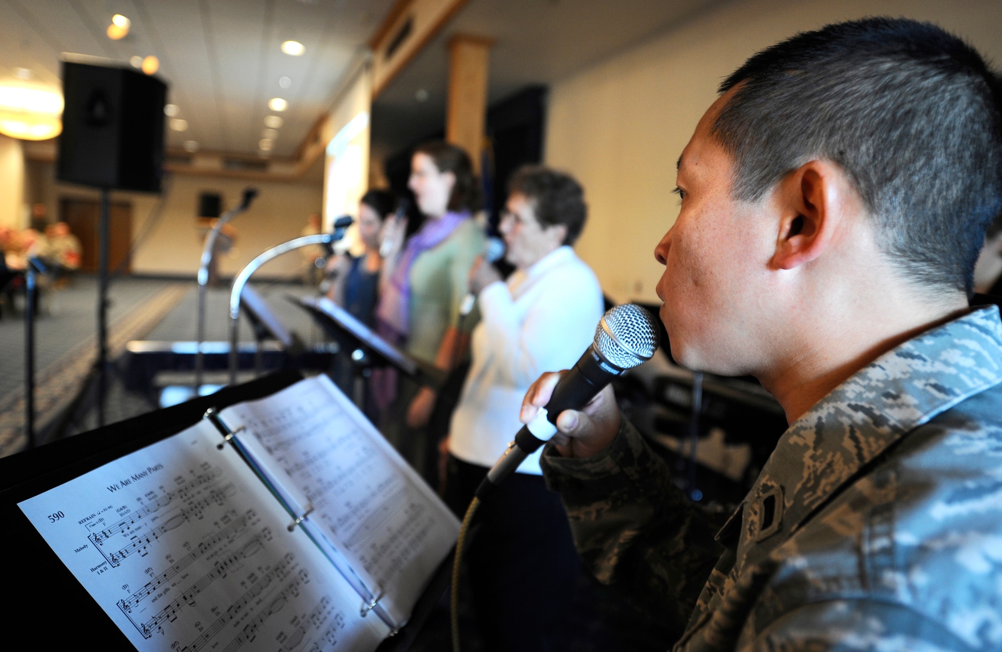 HOLLOMAN AIR FORCE BASE, N.M. -- 1st Lt. Thomas Truong, 846th Test Squadron, sings along with members from the choir during the National Prayer Breakfast, Feb. 25. Airmen gathered early in the morning to hear scriptures and say prayers during the annual event. The annual prayer breakfast, hosted by the 49th Fighter wing chapel, was open to the base populace, regardless of religious preference. (U.S. Air Force photo by Airman 1st Class Veronica Stamps) 